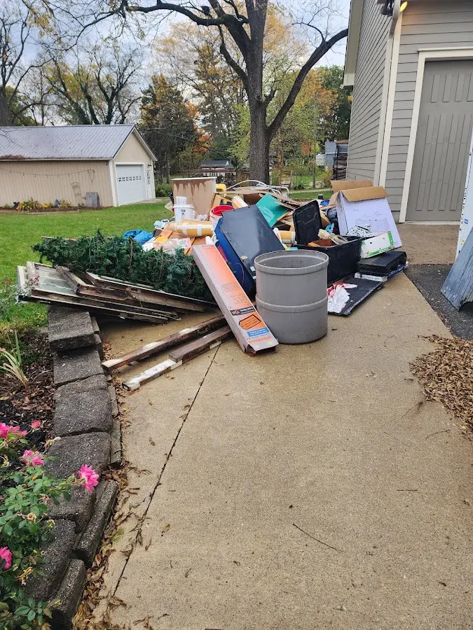 Dumpster being loaded with debris for Estate Cleanout Dumpster Rental in Clive